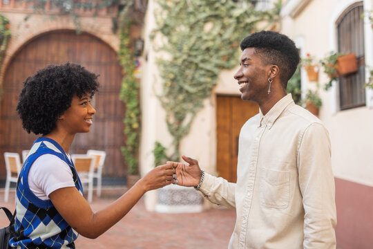 young black couple of friends walking in the city