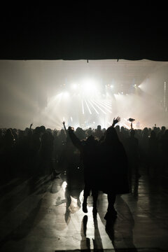 Silhouettes of crowd dancing on music Festival