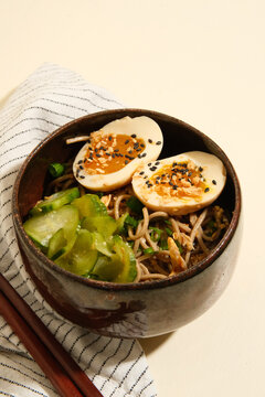 Traditional bowl of soba noodle salad and marinated egg. 