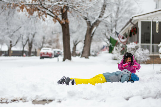 Kids playing in snow in neighborhood
