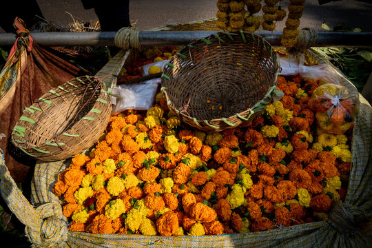 A large bag of marigold flowers for sale on the street in India