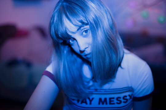 Portrait of young woman with blue neon light