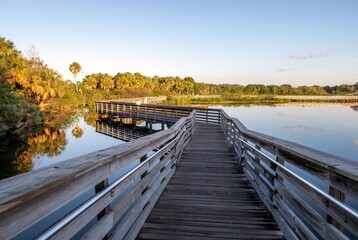 Elevated boardwalk at Green Cay Nature Center and Wetlands in Boynton Beach, Florida on clear cloudless sunny morning.