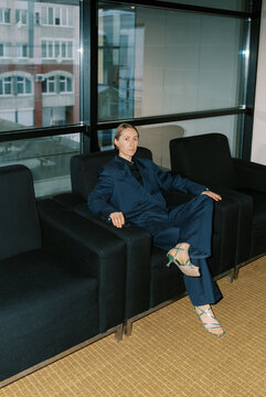 Androgyne woman wearing man classic suite  indoors