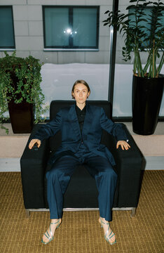 Androgyne woman wearing man classic suite  indoors