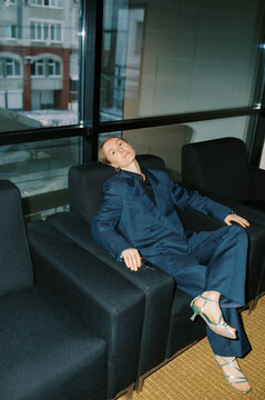 Tired woman wearing man classic suite  indoors