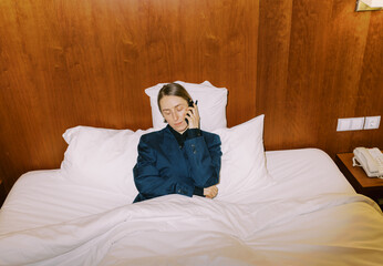 woman wearing man classic suite on the phone
