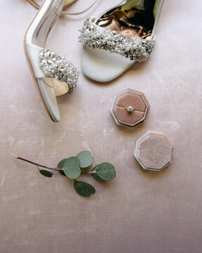 Engagement ring in box  with wedding sandals
