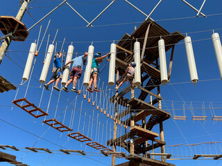 Family adventure balance on Rope course  park outdoors