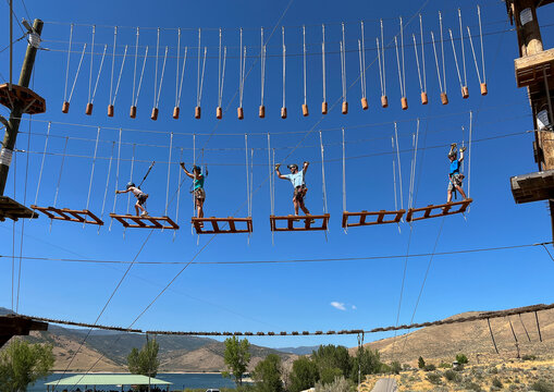 Family together obstacle balance Rope course Adventure park outdoors