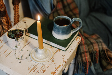 downward view of lighted candle on side table