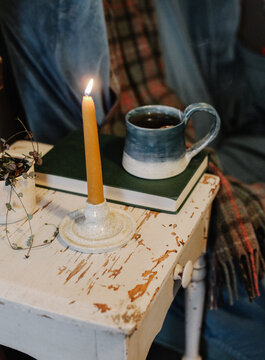 mug of tea and lighted candle