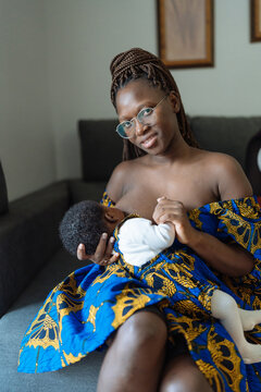 Tender mother feeding baby with breast