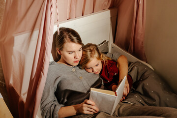 Mother and daughter reading fairy tale 