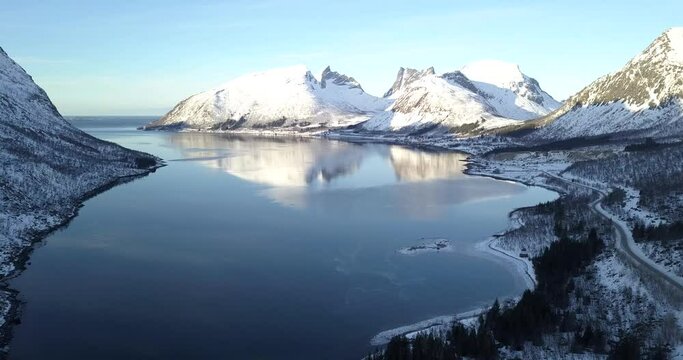 Relaxing and stunning aerial footage by drone over a fiord in north Norway during winter season