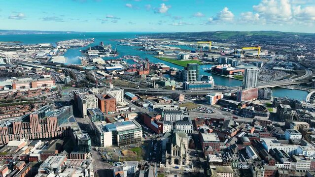 Aerial video of Belfast Cityscape Skyline on a sunny day in Northern Ireland