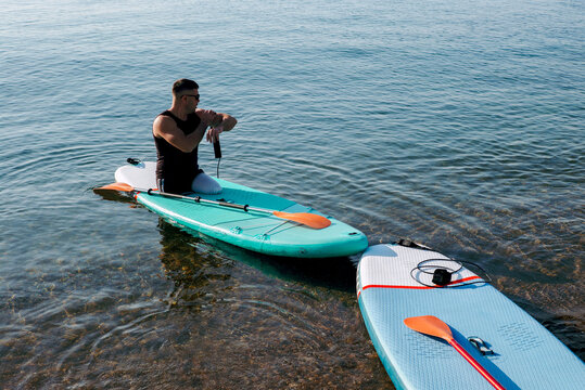 Disabled man with no legs getting ready to walk on Sup board