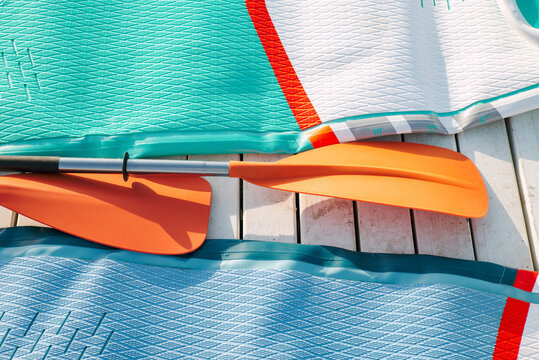 Abstract shot of two SUP boards and paddles in preparation for use