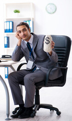 Young male accountant working in the office