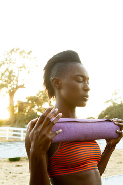 Focused Woman With Yoga Mat