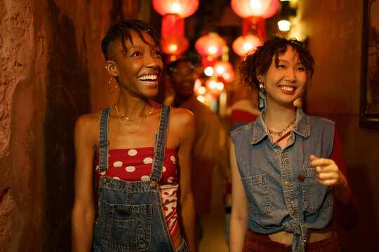 Friends walking down lantern alley together