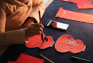 Make traditional Chinese New Year brush calligraphy decorations