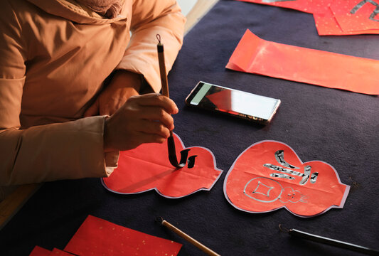 Make traditional Chinese New Year brush calligraphy decorations