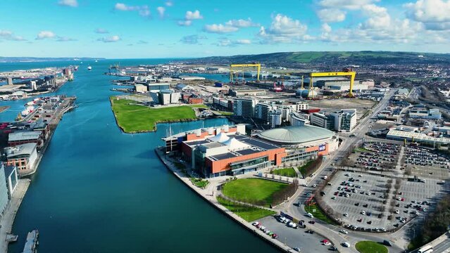Aerial video of Samson and Goliath Cranes at Harland and Wolff Shipyard Dockyard where RMS Titanic was built at Titanic Quarter Belfast Northern Ireland 