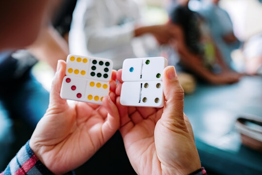 Woman's hands holding dominoes
