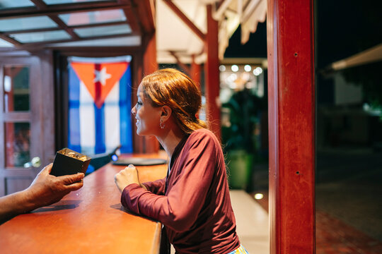 Cuban woman receiving order in street restaurant