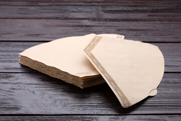 New paper coffee filters on wooden table