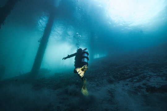 scuba diver under pier
