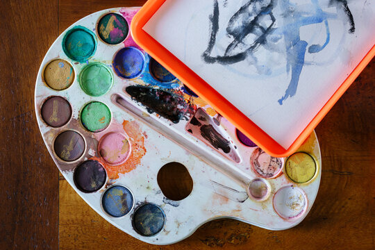 Watercolor palette and a blue aquarelle painting