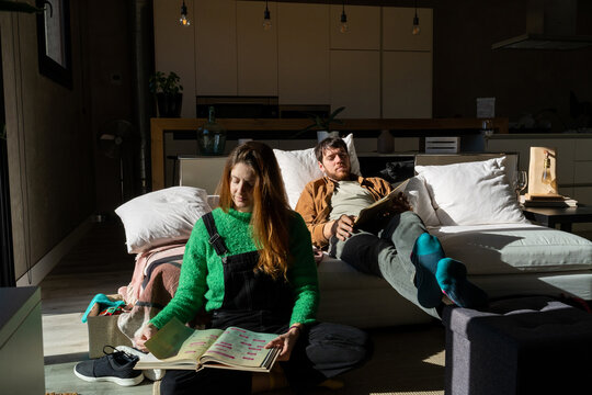 Couple Relaxing On Sofa At Home