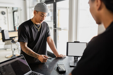 Making Payment At Barbershop