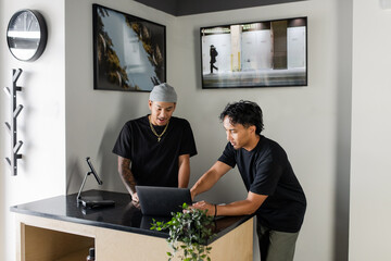 Two Coworkers On Laptop