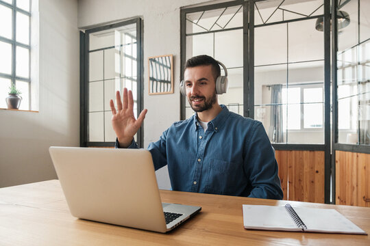 Friendly man waving hand in Video Conference