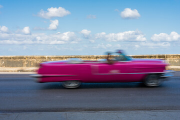 Antique Pink Car Driving On A Malecon Highway