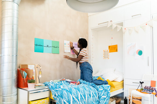 teen decorating  her bedroom 