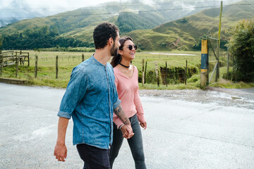 Happy Latin couple walking down a street