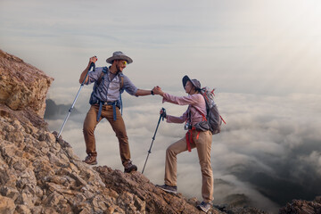 Tourists with backpacks hike on rocky top mountain trekking is adventure sport for Traveller who...
