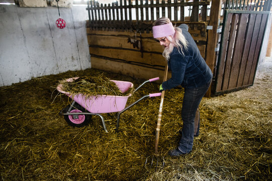  Frau cleaning the horse paddock