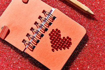 red heart in a red notepad