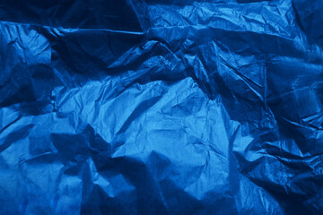 Dark navy blue solid color paint on creased messy wrap blank recycled paper textured background with space