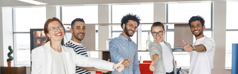 Diverse group of colleagues enjoying working together in an office. Teamwork concept