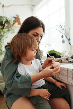 Mom with little son preparing for Easter.