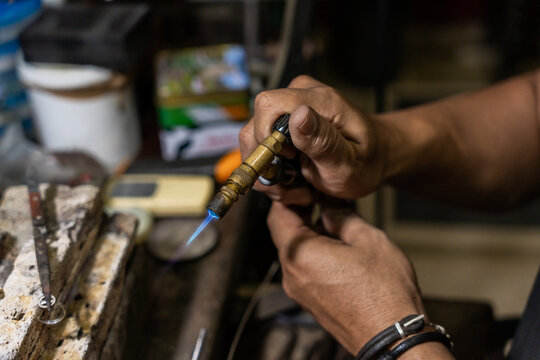 Close Up Of Anonymous Jeweler Soldering A Ring