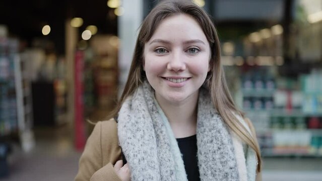 Young blonde woman smiling confident standing at street