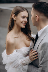 Above view of beautiful bride wearing wedding dress having photo shoot with handsome groom. Beloved couple getting married, looking at each other. Concept of wedding and marriage.