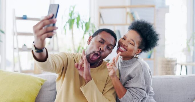 Black couple, selfie and funny face in home on sofa with peace sign, tongue and comic bonding in living room. Man, woman and profile picture photography with care, happiness and love on social media
